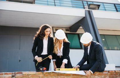 three-architects-wearing-helmets